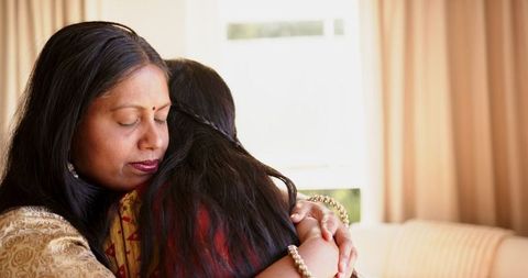 Mother and Daughter Embracing in Warm Emotional Hug