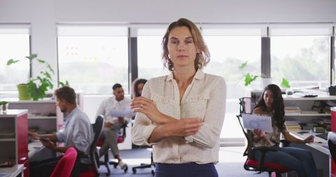 Confident Businesswoman in Modern Office with Team
