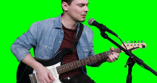 Man Singing and Playing Electric Guitar Against Green Screen - Download Free Stock Images Pikwizard.com