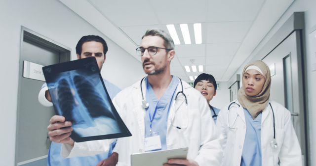 Diverse Team of Doctors Analyzing X-Ray in Hospital Corridor - Download Free Stock Images Pikwizard.com