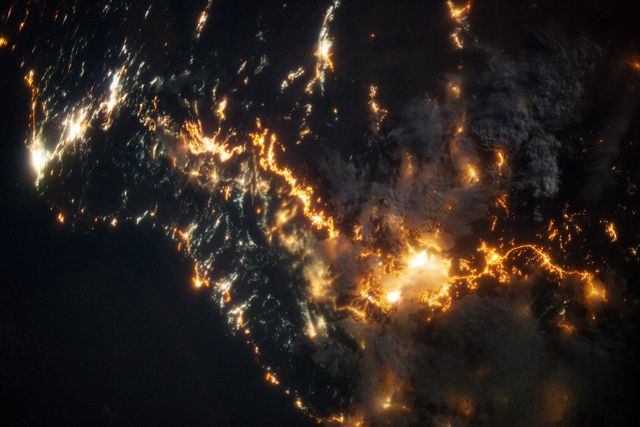 This striking image of the coastline of southwestern Saudi Arabia was taken by astronauts on the International Space Station. Patchy cloud cover partially obscures and blurs the city lights, especially in the vicinity of Khamis Mushait and Abha.  While much of the country is lightly populated desert—and relatively dark at night due to lack of city and roadway lights—the southwestern coastal region has a more moderate climate and several large cities. Three brightly lit urban centers are visible at image top left: Jeddah, Mecca, and Taif. Jeddah is the gateway city for Islamic pilgrims going to nearby Mecca, a religious journey known as the Hajj. Taif is located on the slopes of the Sarawat Mountains and provides a summer retreat for the Saudi government from the desert heat of the capital, Riyadh.  Bright yellow-orange lighting marks highways that parallel the trend of the Asir Mountains (image center), connecting Mecca to the resort cities of Al Bahah and Abha. Smaller roadways, lit with blue lights, extend to the west to small cities along the Red Sea coastline. The bright yellow-orange glow of the city of Abha is matched by that of Khamis Mushait (or Khamis Mushayt) to the northeast. The brightly lit ribbon of highway continues towards other large cities to the south (Jazan, not shown) and southeast (Najran, not shown).  Astronaut photograph ISS036-E-25802 was acquired on July 26, 2013, with a Nikon D3S digital camera using a 50 millimeter lens, and is provided by the ISS Crew Earth Observations experiment and Image Science &amp; Analysis Laboratory, Johnson Space Center. The image was taken by the Expedition 36 crew. It has been cropped and enhanced to improve contrast, and lens artifacts have been removed. The International Space Station Program supports the laboratory as part of the ISS National Lab to help astronauts take pictures of Earth that will be of the greatest value to scientists and the public, and to make those images freely available on the Internet. Additional images taken by astronauts and cosmonauts can be viewed at the NASA/JSC Gateway to Astronaut Photography of Earth. Caption by William L. Stefanov, Jacobs/JETS at NASA-JSC.  Instrument:  ISS - Digital Camera  More info: <a href="http://1.usa.gov/13TqPcr" rel="nofollow">1.usa.gov/13TqPcr</a>  Credit: <b><a href="http://www.earthobservatory.nasa.gov/" rel="nofollow"> NASA Earth Observatory</a></b>  <b><a href="http://www.nasa.gov/audience/formedia/features/MP_Photo_Guidelines.html" rel="nofollow">NASA image use policy.</a></b>  <b><a href="http://www.nasa.gov/centers/goddard/home/index.html" rel="nofollow">NASA Goddard Space Flight Center</a></b> enables NASA’s mission through four scientific endeavors: Earth Science, Heliophysics, Solar System Exploration, and Astrophysics. Goddard plays a leading role in NASA’s accomplishments by contributing compelling scientific knowledge to advance the Agency’s mission.  <b>Follow us on <a href="http://twitter.com/NASA_GoddardPix" rel="nofollow">Twitter</a></b>  <b>Like us on <a href="http://www.facebook.com/pages/Greenbelt-MD/NASA-Goddard/395013845897?ref=tsd" rel="nofollow">Facebook</a></b>  <b>Find us on <a href="http://instagram.com/nasagoddard?vm=grid" rel="nofollow">Instagram</a></b>