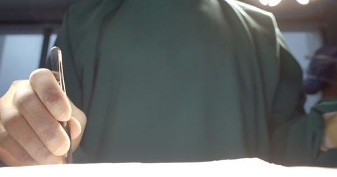 Surgeon performing delicate operation in surgical theatre