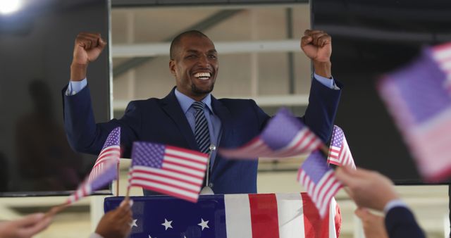 African American Politician Celebrating Victory at Rally Involving American Flags - Download Free Stock Images Pikwizard.com