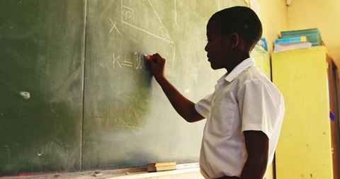 Young Boy Solving Math Problemon Chalkboard - Download Free Stock Images Pikwizard.com