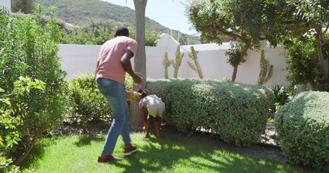 Father and Daughter Exploring Garden with Basket in Hand