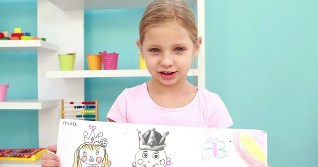 Happy Preschool Girl Showcasing Her Drawing in Classroom - Download Free Stock Images Pikwizard.com