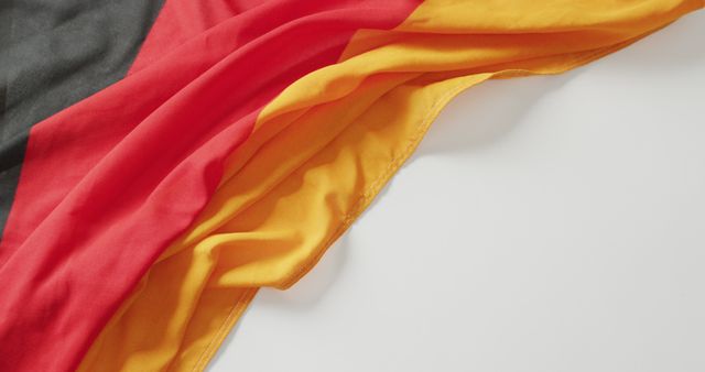 Image of creased flag of germany lying on white background. nationality, state symbols, patriotism and independence concept.