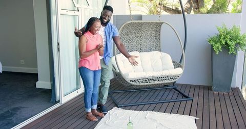 Happy Couple Preparing Patio Picnic Outdoors