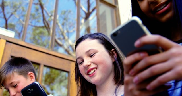 Joyful Children Socializing with Smartphones Outdoors - Download Free Stock Images Pikwizard.com