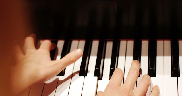 Close-up of hands skillfully playing piano keys. Suitable for use in music education materials, artistic performances, and advertisements promoting musical instruments or music lessons. Captures the essence of musical practice and passion.