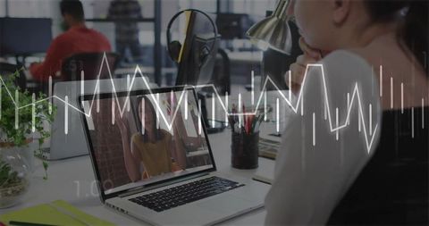 Woman attending remote meeting in coworking space with laptop and waveform overlay
