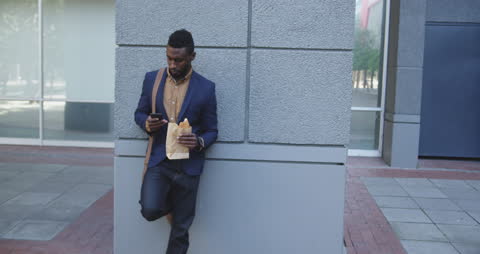 Businessman Enjoying Lunch Break with Phone in Urban Setting