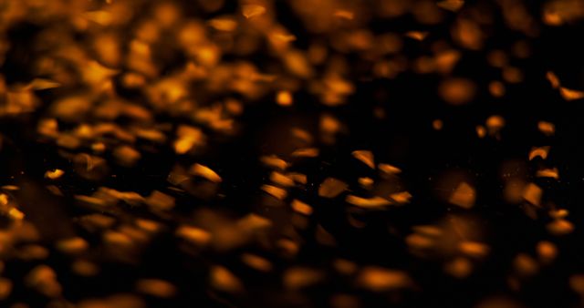 Glowing embers create a warm, abstract background. The image captures the essence of heat and energy, ideal for themes of fire and warmth.