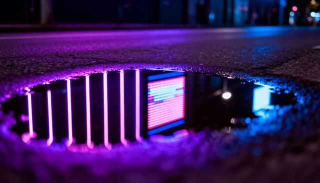 Neon reflection on wet asphalt at night with pink blue led grid and vertical bars, moody