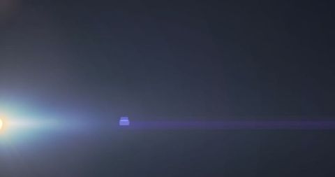 Dynamic Lens Flare with Moving Spotlight Over Dark Background - Download Free Stock Images Pikwizard.com
