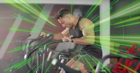 Muscular man intently cycling on gym cardio machine with dynamic motion lines