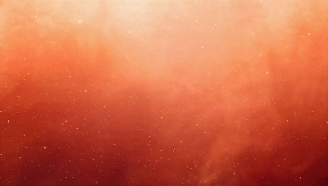 Glowing orange-red nebula field with gold speckles and soft cosmic glow