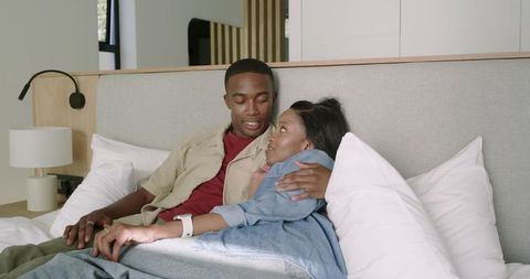 Affectionate Couple Relaxing on Bed in Modern Bedroom
