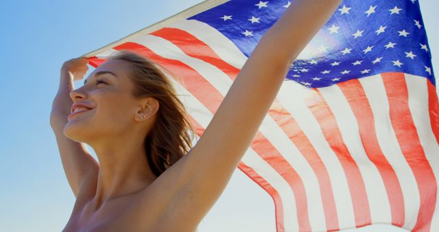 Cheerful Young Woman Holding American Flag on Sunny Day - Download Free Stock Images Pikwizard.com