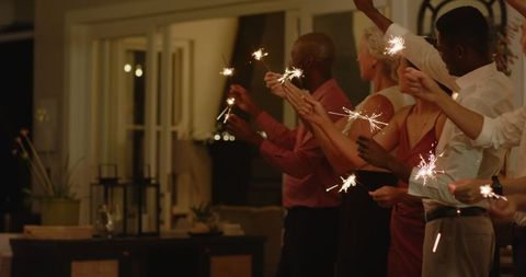 Couple Celebrating with Sparklers at Romantic Wedding Reception