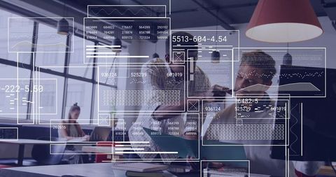 Team collaborating over laptop analyzing data with HUD overlays in modern coworking office