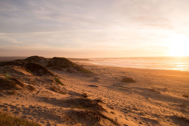 Golden Sunset Over Serene Sandy Beach - Download Free Stock Photos Pikwizard.com