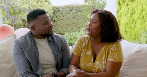 African American Couple Relaxing on Cozy Patio Together