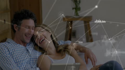 Couple Engaging with Digital Network on Tablet at Home