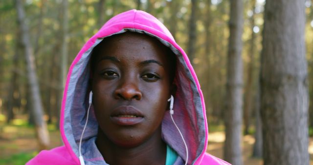 Determined Athlete Jogging with Earphones in Forest - Download Free Stock Images Pikwizard.com