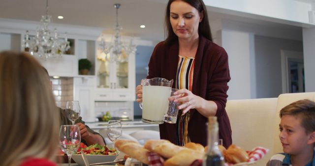 Woman Serving Lemonade at Family Dinner Table - Download Free Stock Images Pikwizard.com