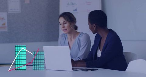Two professionals collaborating over laptop analyzing charts and dashboard in modern office
