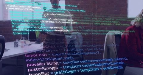 Developers collaborating under colorful source code overlay in open-plan coworking office