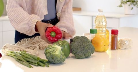 Mid Adult Woman Preparing Fresh Vegetables in Modern Kitchen