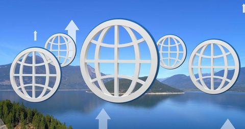 Digital globes and arrows overlaying scenic lake view