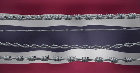 Barbed wire running across flaglike fabric stripes conveying border security tension