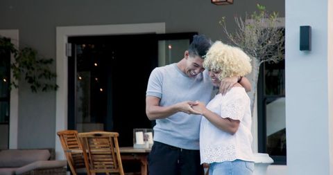 Man Proposing to Smiling Partner on Outside Terrace