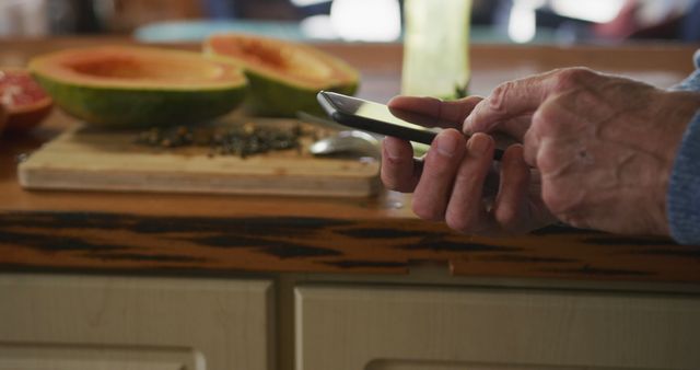 Senior Man Using Smartphone in Kitchen with Fruit - Download Free Stock Images Pikwizard.com