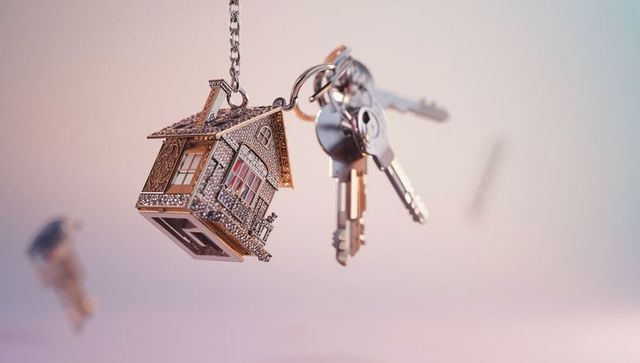 House-Shaped Keychain and Keys Hanging on Gradient Background