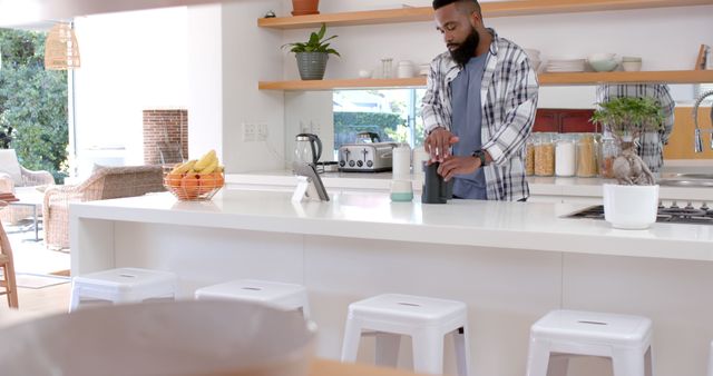 Man Preparing Morning Drink in Modern Kitchen - Download Free Stock Images Pikwizard.com