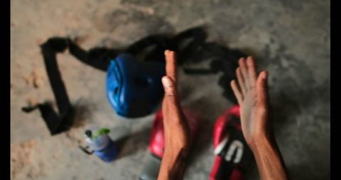 Boxer Preparing for Training with Chalky Hands in Gym