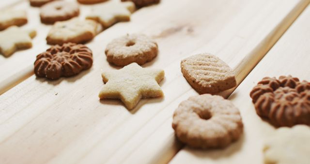 Image of assorted tasty christmas cookies on pale wooden background. christmas, tradition and celebration concept.