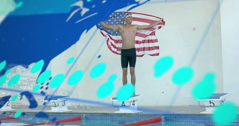 Male Swimmer Celebrating with American Flag on Starting Block 4 at Competition Pool