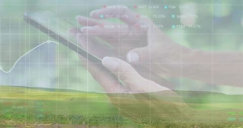 Holding smartphone over pasture displaying financial charts and rural data overlay