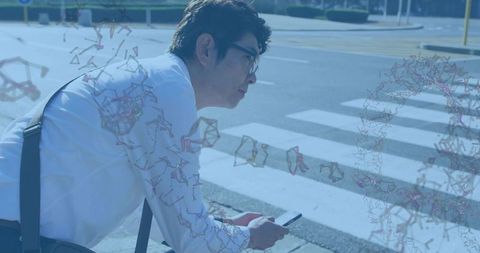 Mature man checking smartphone at urban crosswalk with digital geometry overlay