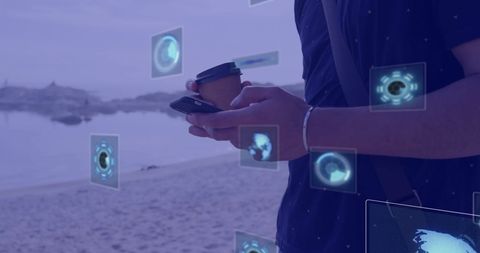 Man Interacting with Digital Interface on Smartphone by Beach