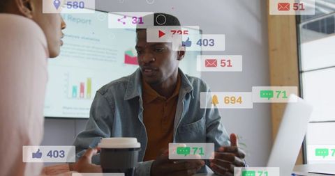 Professional presenting social media analytics with smartphone and laptop in team meeting