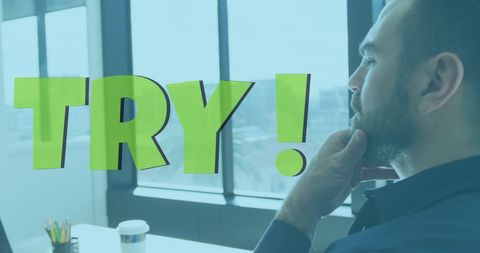 Motivated businessman reflecting on success in office