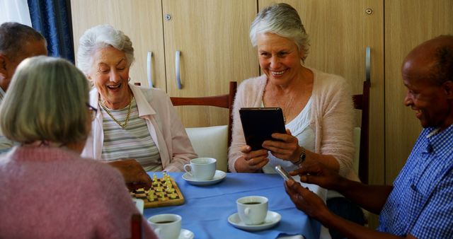 Group of Senior Friends Socializing with Games and Technology in Cozy Setting - Download Free Stock Images Pikwizard.com