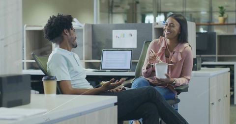 Coworkers cooperating in casual office environment
