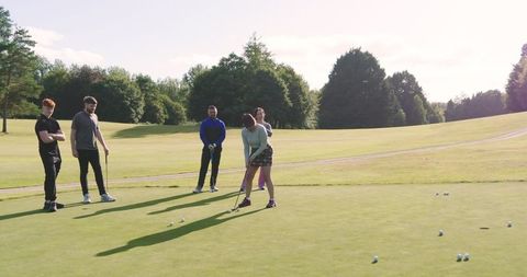 Golf Enthusiasts Enjoying Leisurely Day on Scenic Green